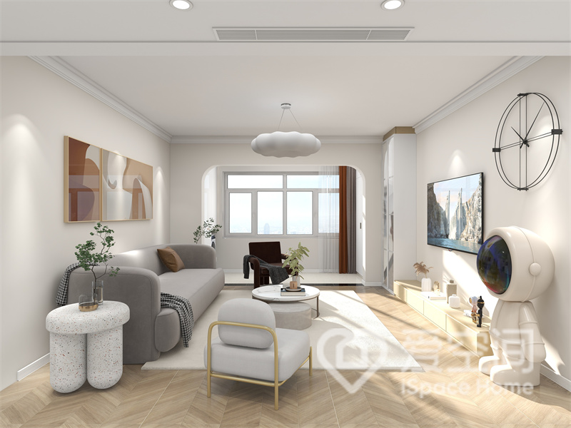 客厅以奶白色为基调，灰色沙发舒适高雅，装饰画配以温润的色彩，一进门便令人怦然心动。