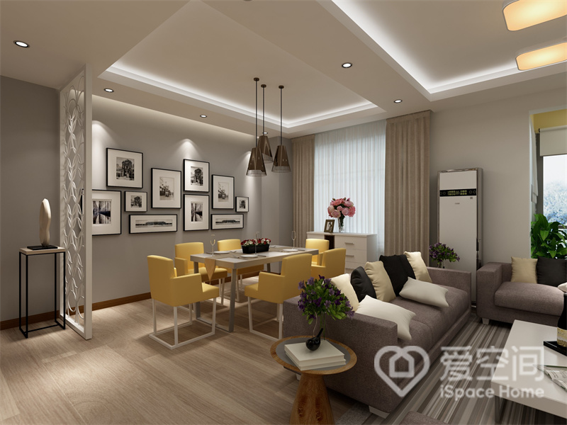 客厅与餐厅衔接式设计，空间显得十分宽敞，沙发作为空间隔断，很好的分隔了两个功能区，黄色沙发成为空间的跳色点缀，令空间充满生机。