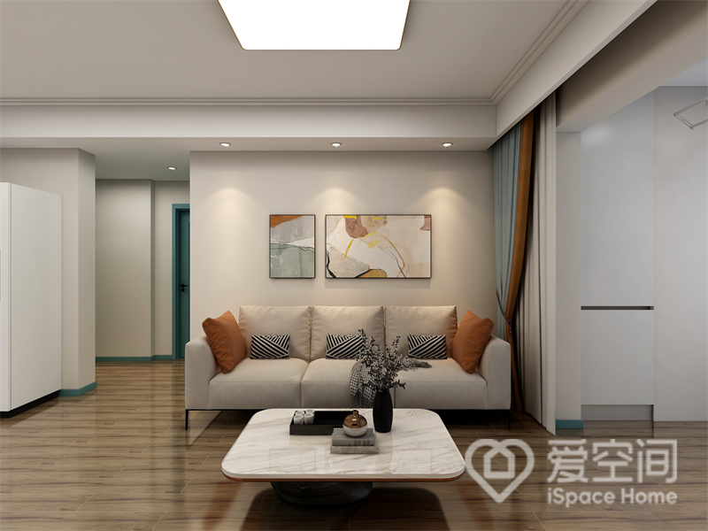 为了保证足够出彩的视觉效果，米白色沙发居中放置，顶面筒灯有序且不繁杂，渲染出温馨的生活空间。