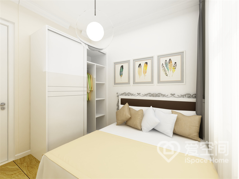 白色衣柜勾勒出次卧空间的边界，床头配以文艺装饰画点缀，使空间在温馨的基础上更具视觉感。