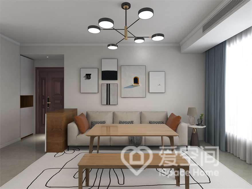 客厅线条简单，米白为主，利用装饰画、光线和家具表达出空间的舒适情绪，营造出冷静淡雅的生活氛围。