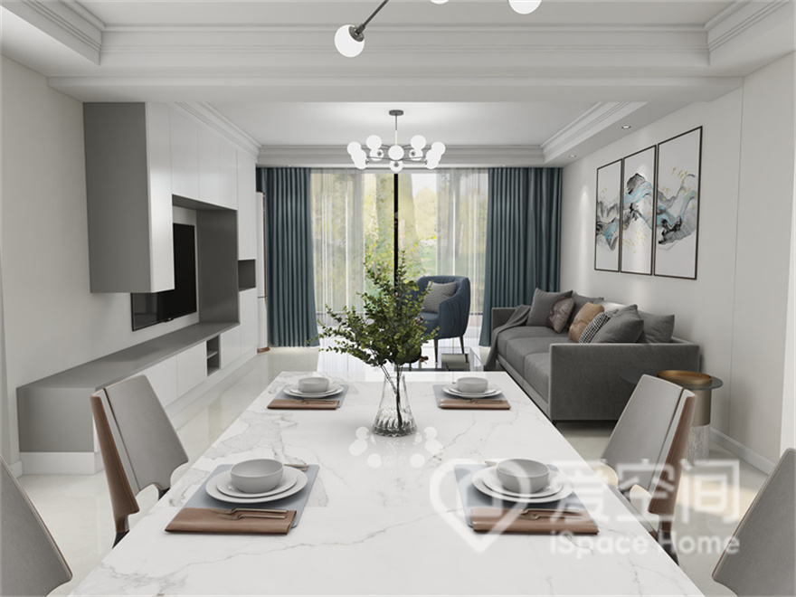 客厅与餐厅衔接设计，灰色与白色的碰撞彰显出现代生活美学里的温润与精致，呈现出素雅大气的空间氛围。