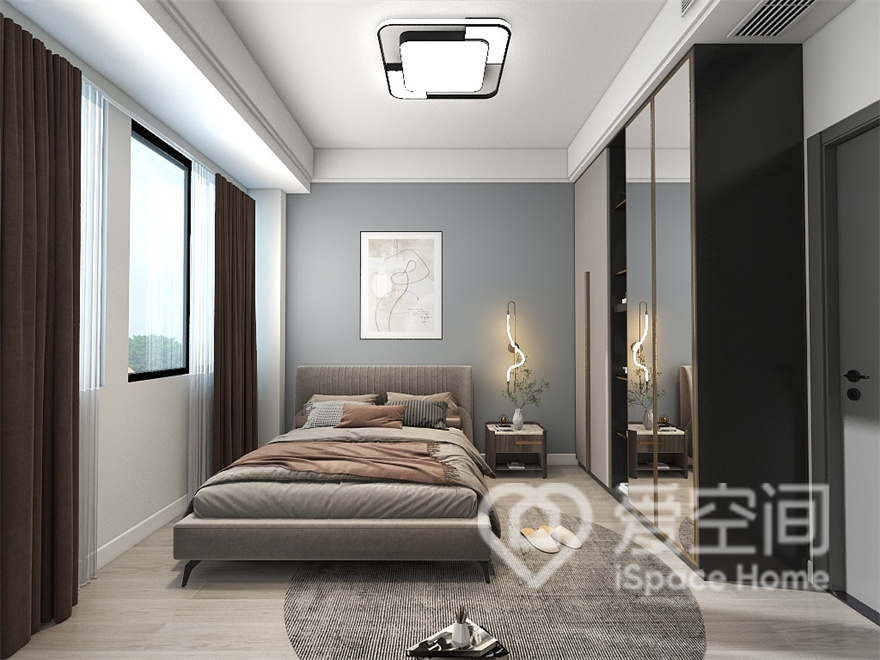 蓝色调背景墙充满温暖的气息，不同的材质在次卧空间中相互呼应，打造出简约而高级的空间氛围。