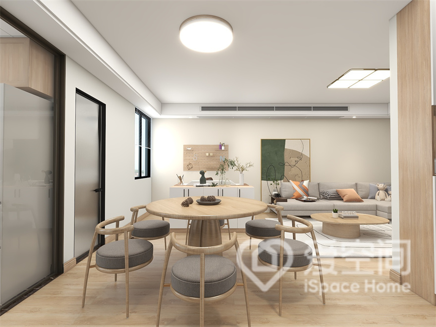 餐厅通铺原木地板，背景做了白色硬包，原木餐桌椅的融入奠定了空间优雅简约的基调，视觉效果舒适温馨。