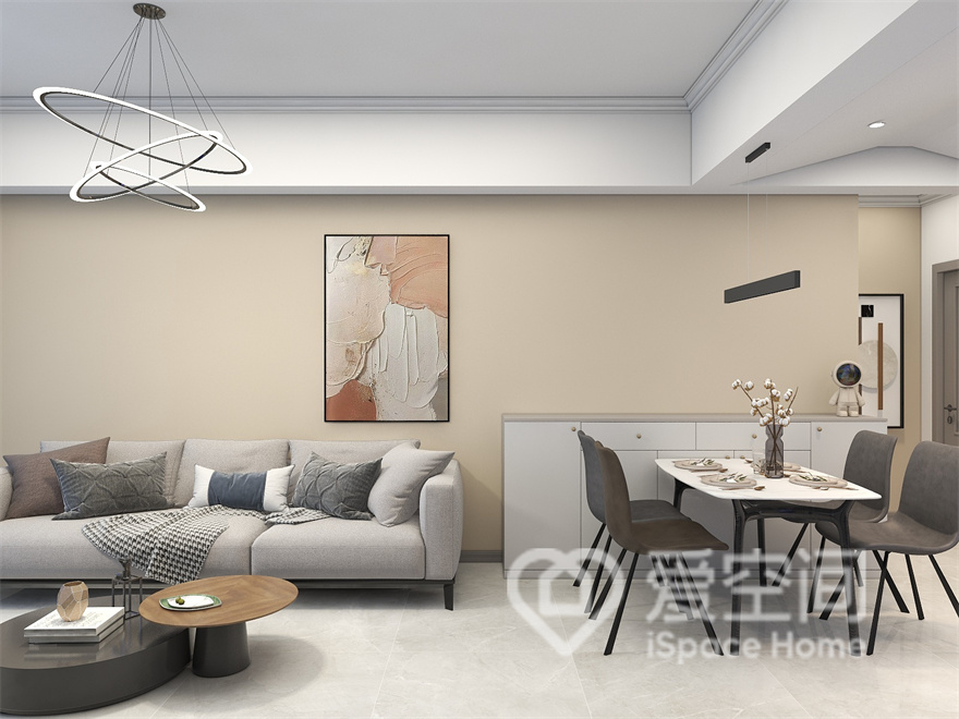 设计师将客厅与餐厅相互连接，让空间变得更加通透一体，米色背景配以灰褐色家具，展示出现代风格的大气。